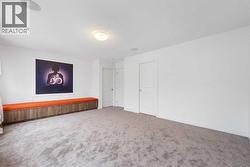 The expansive primary bedroom also features custom seating.. - 