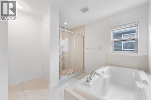 The luxurious five-piece ensuite.. - 99 Evansglen Circle Nw, Calgary, AB - Indoor Photo Showing Laundry Room