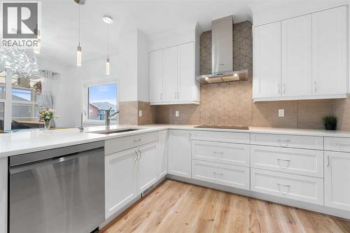 This gorgeous kitchen offers ample quartz countertop space… - 99 Evansglen Circle Nw, Calgary, AB - Indoor Photo Showing Kitchen With Upgraded Kitchen