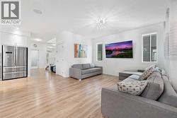 The spacious living room features numerous windows that allow an abundance of natural sunlight to fill the space.. - 