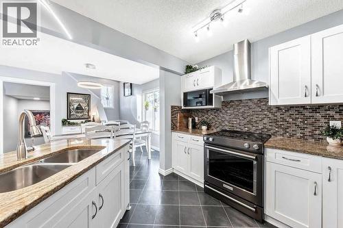 361 Cimarron Boulevard, Okotoks, AB - Indoor Photo Showing Kitchen With Double Sink With Upgraded Kitchen