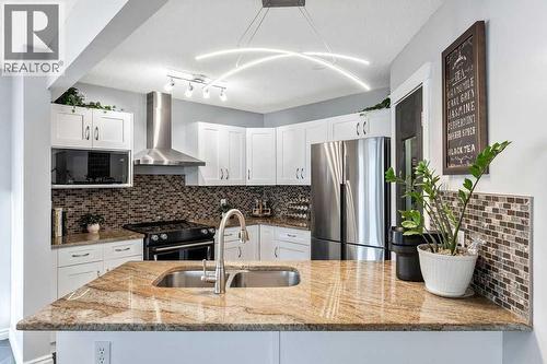 Modernized kitchen with timeless finishes - 361 Cimarron Boulevard, Okotoks, AB - Indoor Photo Showing Kitchen With Stainless Steel Kitchen With Double Sink With Upgraded Kitchen