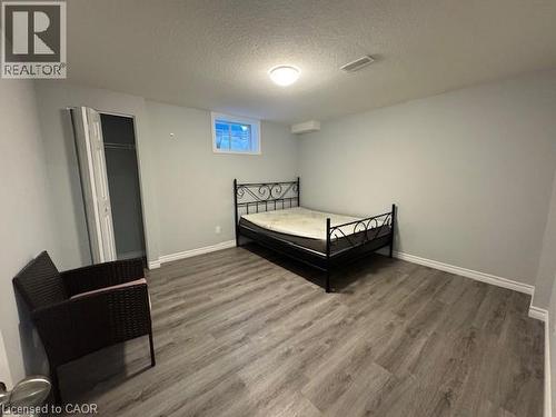 Bedroom with wood finished floors, a textured ceiling, and a closet - 509 St Moritz Avenue Unit# Lower, Waterloo, ON - Indoor Photo Showing Other Room