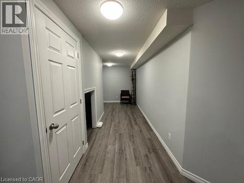 Hall with a textured ceiling and dark wood finished floors - 509 St Moritz Avenue Unit# Lower, Waterloo, ON - Indoor Photo Showing Other Room