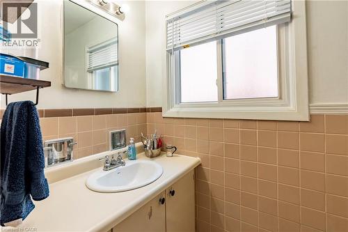 Bathroom with vanity, tile walls, and wainscoting - 62 Moore Avenue, Kitchener, ON - Indoor Photo Showing Bathroom