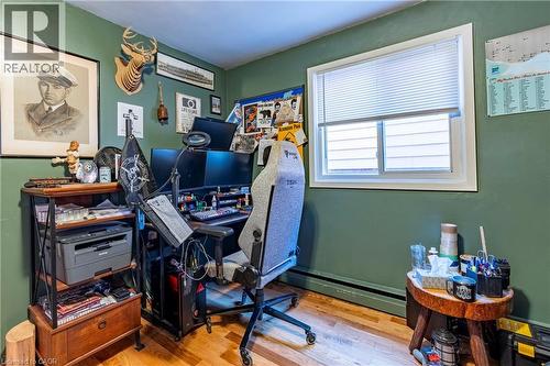 Home office featuring wood finished floors and a baseboard heating unit - 62 Moore Avenue, Kitchener, ON - Indoor Photo Showing Office