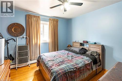 Bedroom with light wood-style flooring and a ceiling fan - 62 Moore Avenue, Kitchener, ON - Indoor Photo Showing Bedroom