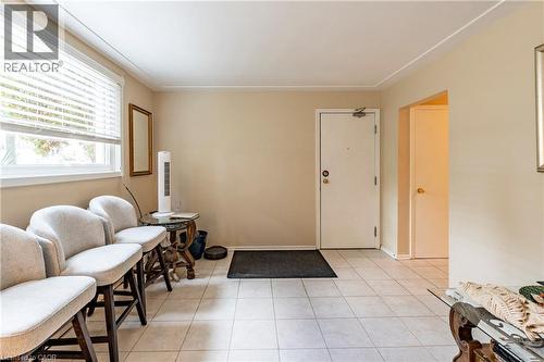 Entrance foyer featuring light tile patterned floors and baseboards - 62 Moore Avenue, Kitchener, ON - Indoor Photo Showing Other Room