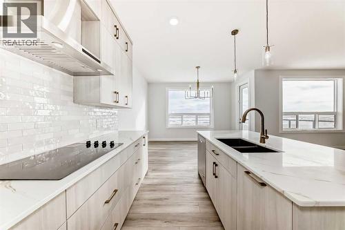 100 Corner Glen Manor Ne, Calgary, AB - Indoor Photo Showing Kitchen With Double Sink With Upgraded Kitchen