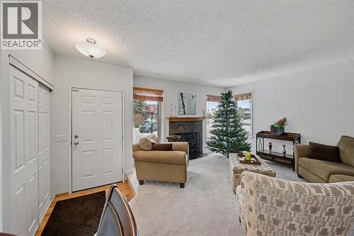 34 Woodglen Crescent Sw, Calgary, AB - Indoor Photo Showing Living Room With Fireplace