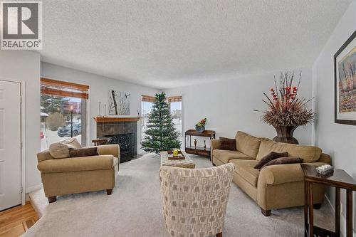34 Woodglen Crescent Sw, Calgary, AB - Indoor Photo Showing Living Room With Fireplace