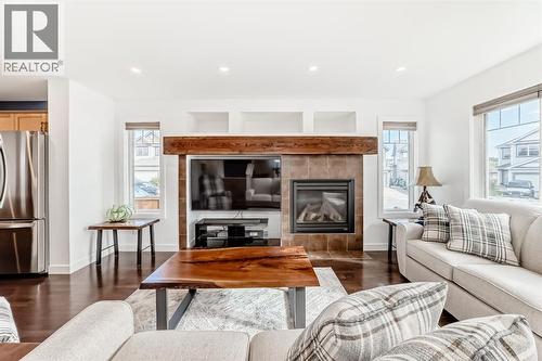 182 Sunset Heights, Cochrane, AB - Indoor Photo Showing Living Room With Fireplace