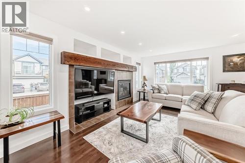 182 Sunset Heights, Cochrane, AB - Indoor Photo Showing Living Room With Fireplace