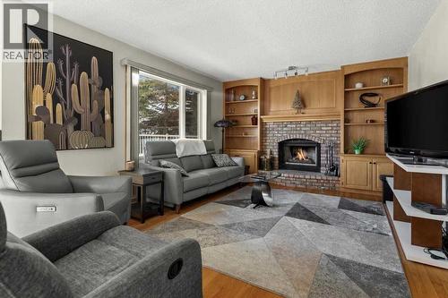 332 Hawkstone Close Nw, Calgary, AB - Indoor Photo Showing Living Room With Fireplace