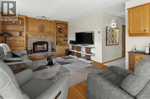 332 Hawkstone Close Nw, Calgary, AB - Indoor Photo Showing Living Room With Fireplace