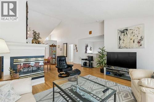312 Prominence Heights Sw, Calgary, AB - Indoor Photo Showing Living Room With Fireplace