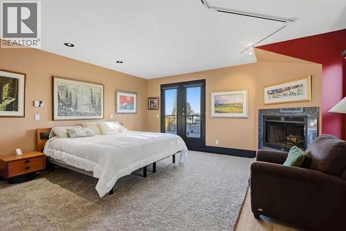 64 Patterson Mews Sw, Calgary, AB - Indoor Photo Showing Bedroom With Fireplace