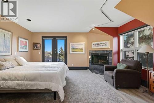 64 Patterson Mews Sw, Calgary, AB - Indoor Photo Showing Bedroom With Fireplace