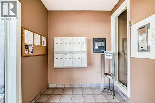 Lobby/mailboxes - 205, 7 Lineham Avenue, Okotoks, AB - Indoor Photo Showing Other Room