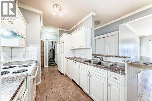 205, 7 Lineham Avenue, Okotoks, AB - Indoor Photo Showing Kitchen With Double Sink