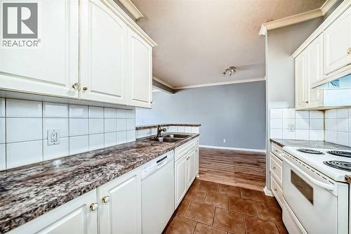 205, 7 Lineham Avenue, Okotoks, AB - Indoor Photo Showing Kitchen With Double Sink