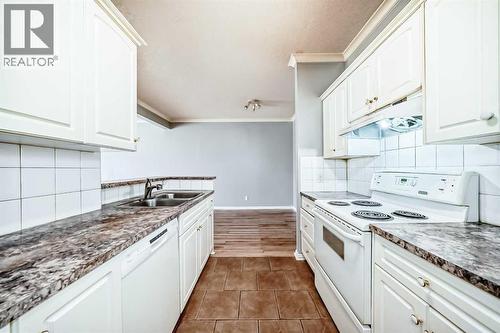 205, 7 Lineham Avenue, Okotoks, AB - Indoor Photo Showing Kitchen With Double Sink