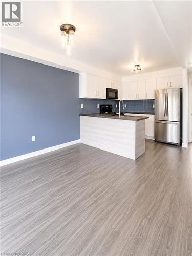 Modern kitchen with white cabinetry and stainless steel appliances - 22 Todd Crescent, Dundalk, ON - Indoor Photo Showing Kitchen