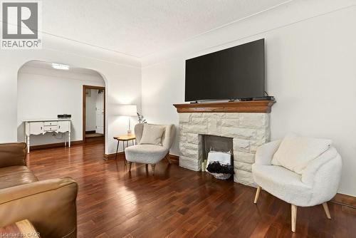 Beautiful cove ceilings, decortive fireplace with wood beam mantel - 17 Gary Avenue, Hamilton, ON - Indoor Photo Showing Living Room With Fireplace