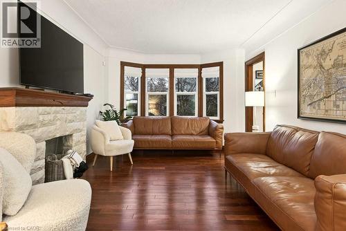 Natural light streams through the west facing updated LR windows - 17 Gary Avenue, Hamilton, ON - Indoor Photo Showing Living Room With Fireplace