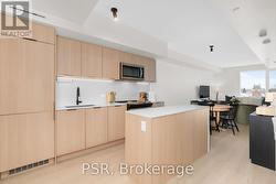 Kitchen w/ Island and built-in appliances - 