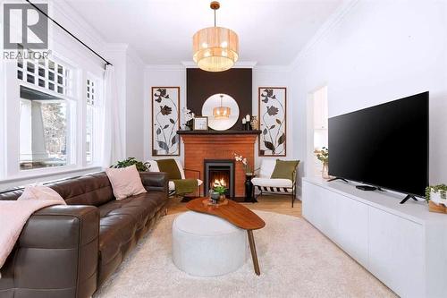 Living Room - 712 5 Street Nw, Calgary, AB - Indoor Photo Showing Living Room With Fireplace