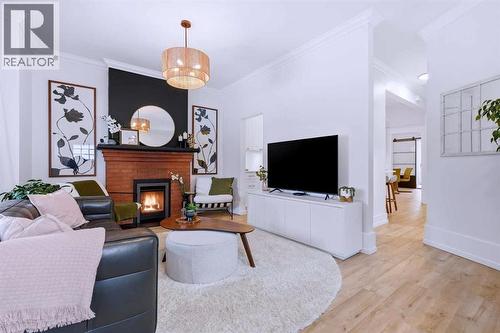 Living Room - 712 5 Street Nw, Calgary, AB - Indoor Photo Showing Living Room With Fireplace