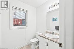 Half bathroom featuring vanity and light tile patterned floors - 