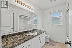 Bathroom featuring vanity and light tile patterned floors - 