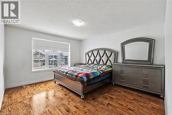 Bedroom featuring wood-type flooring and a textured ceiling - 