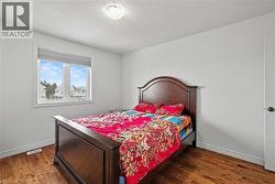 Bedroom with dark wood-type flooring and a textured ceiling - 