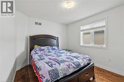 Bedroom with dark wood-style floors - 