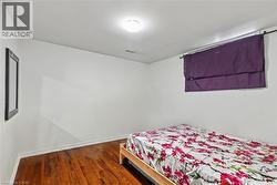 Bedroom with wood finished floors and baseboards - 