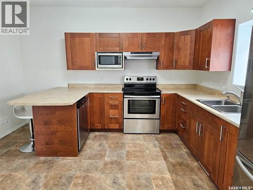 251 5Th Avenue Se, Swift Current, SK - Indoor Photo Showing Kitchen With Stainless Steel Kitchen With Double Sink