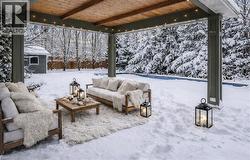 Snow covered patio with an outdoor living space - 
