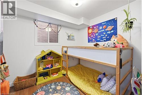 Bedroom featuring wood finished floors - 18 Fraser Avenue, Hamilton, ON - Indoor Photo Showing Other Room