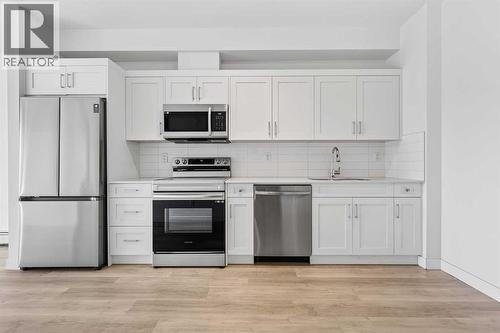 411, 40 Sage Hill Walk Nw, Calgary, AB - Indoor Photo Showing Kitchen With Stainless Steel Kitchen