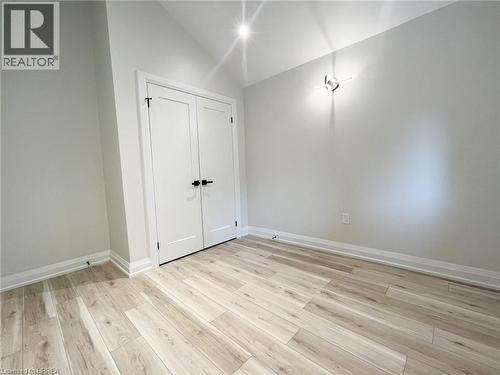 Unfurnished bedroom featuring light wood-type flooring, lofted ceiling, and a closet - 110 Deschene Avenue, Hamilton, ON - Indoor Photo Showing Other Room