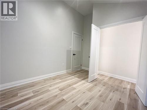 Empty room with light wood-style floors and high vaulted ceiling - 110 Deschene Avenue, Hamilton, ON - Indoor Photo Showing Other Room
