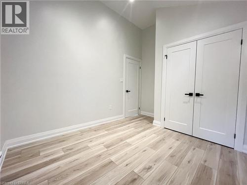 Unfurnished bedroom with light wood finished floors, a closet, and high vaulted ceiling - 110 Deschene Avenue, Hamilton, ON - Indoor Photo Showing Other Room