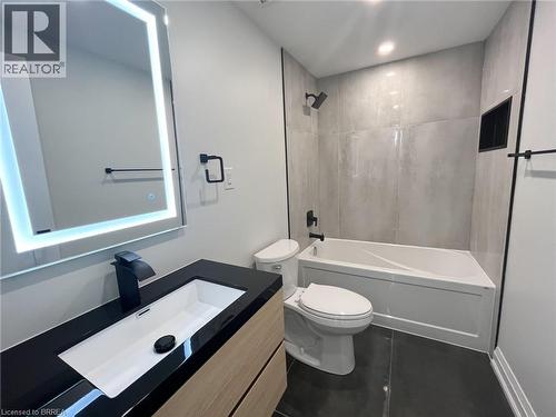 Full bathroom with shower / bath combination, vanity, dark tile patterned flooring, and recessed lighting - 110 Deschene Avenue, Hamilton, ON - Indoor Photo Showing Bathroom