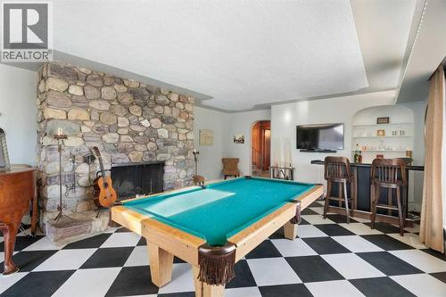 Parlor/Rec Room - 10507 Bradbury Drive Sw, Calgary, AB - Indoor Photo Showing Other Room With Fireplace