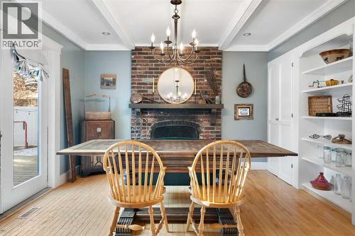 Dining Room - 10507 Bradbury Drive Sw, Calgary, AB - Indoor Photo Showing Dining Room With Fireplace