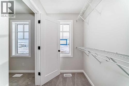 PLEASE NOTE: Photos are of a DIFFERENT Spec Home of the same model – fit and finish may differ. Interior selections and floorplans shown in photos - 158 Bartlett Crescent Se, Calgary, AB - Indoor With Storage