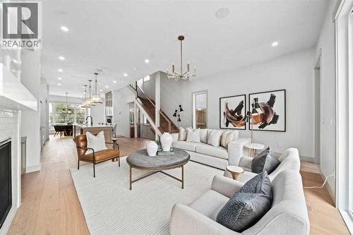 Photo is from a similar past project - 2533 2 Avenue Nw, Calgary, AB - Indoor Photo Showing Living Room With Fireplace